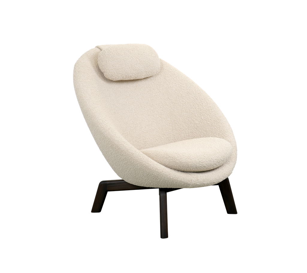 A modern armchair with a soft, curved design in light beige upholstery, featuring a plush backrest and dark wooden legs.