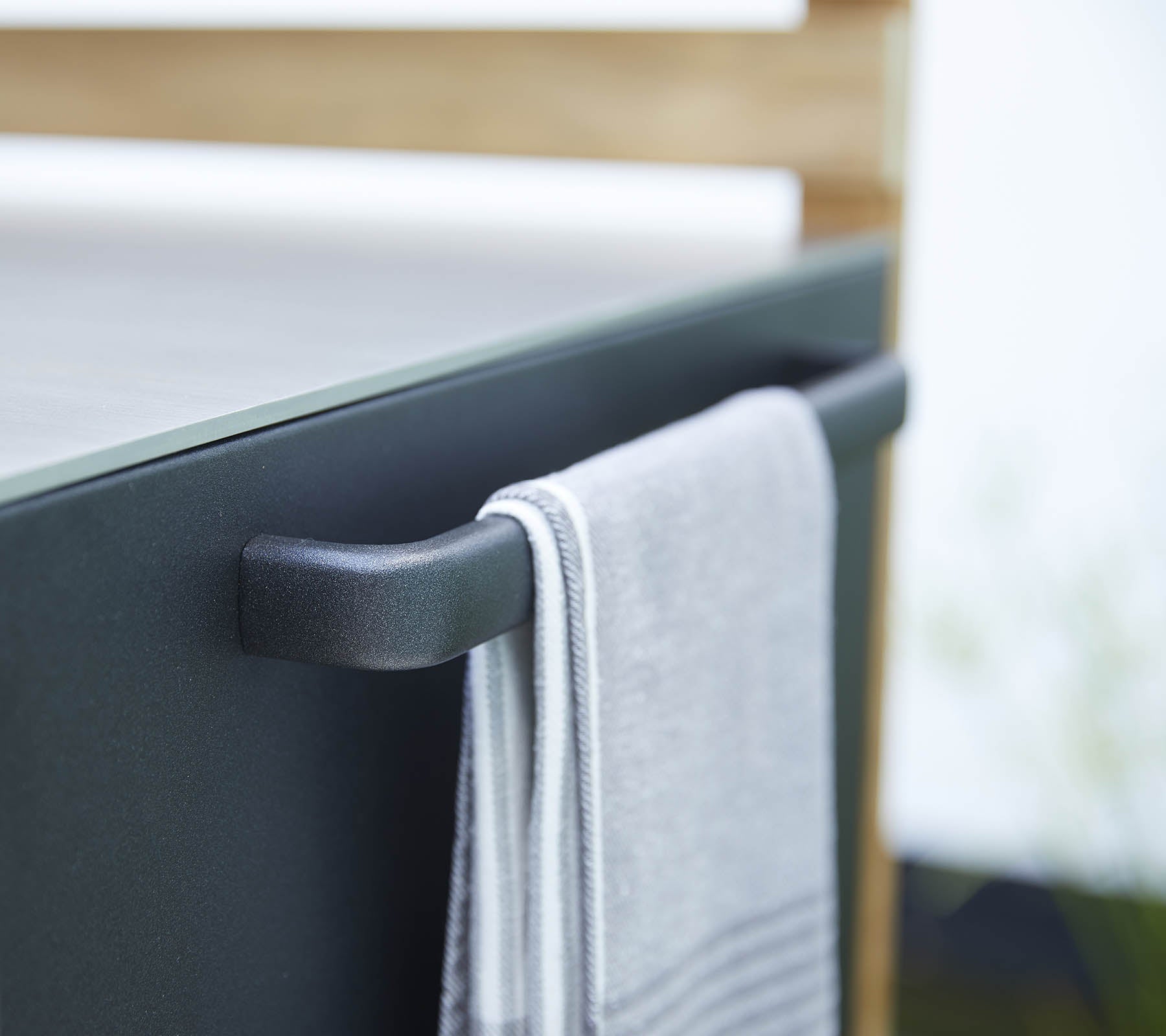 Close-up of a towel hanging on a sleek, modern handle, showcasing a stylish design element.