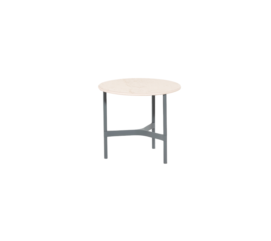 Round table with a light-colored top and a grey three-legged base, designed for versatile use in various settings.