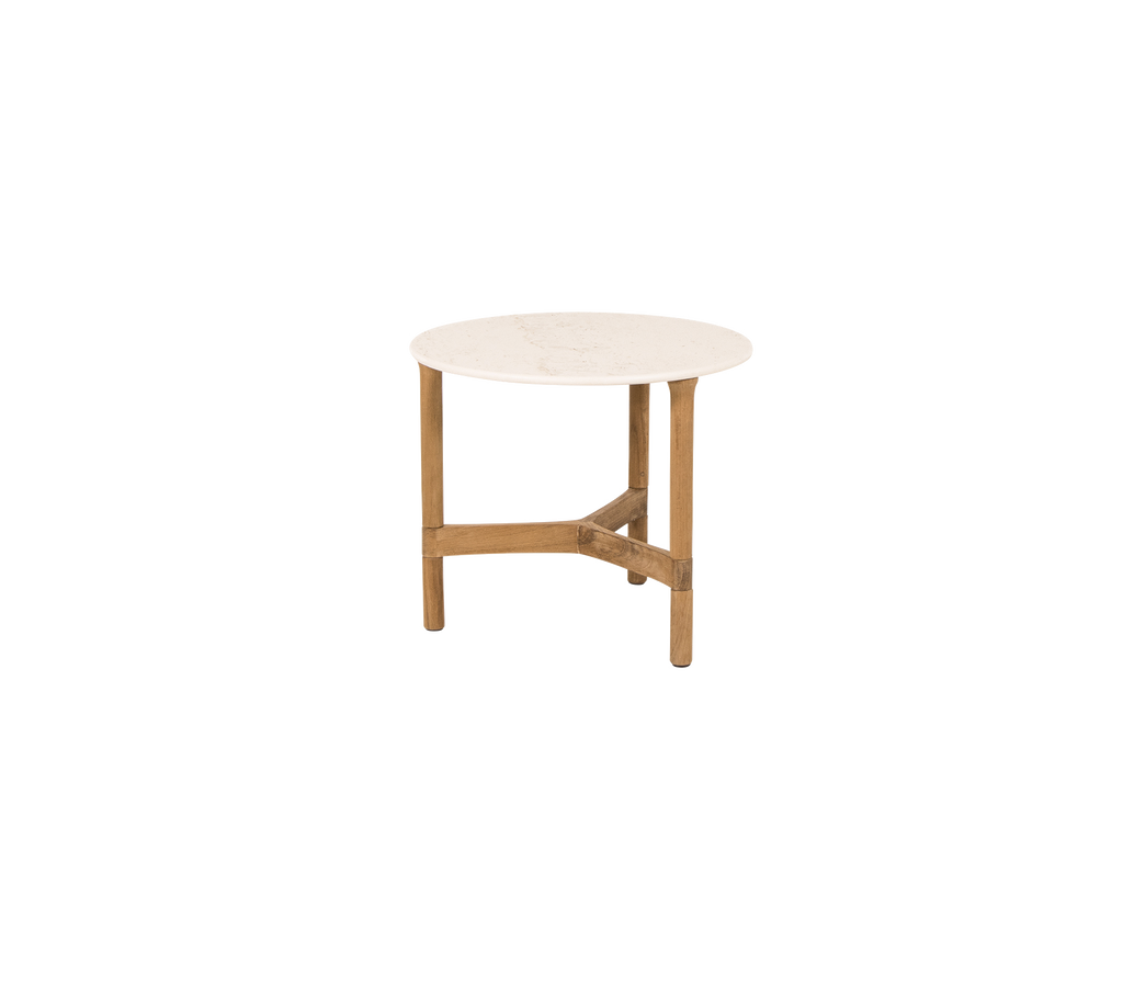 Round table with a light-colored surface and a wooden base, featuring a crossed support for stability. Ideal for various settings.