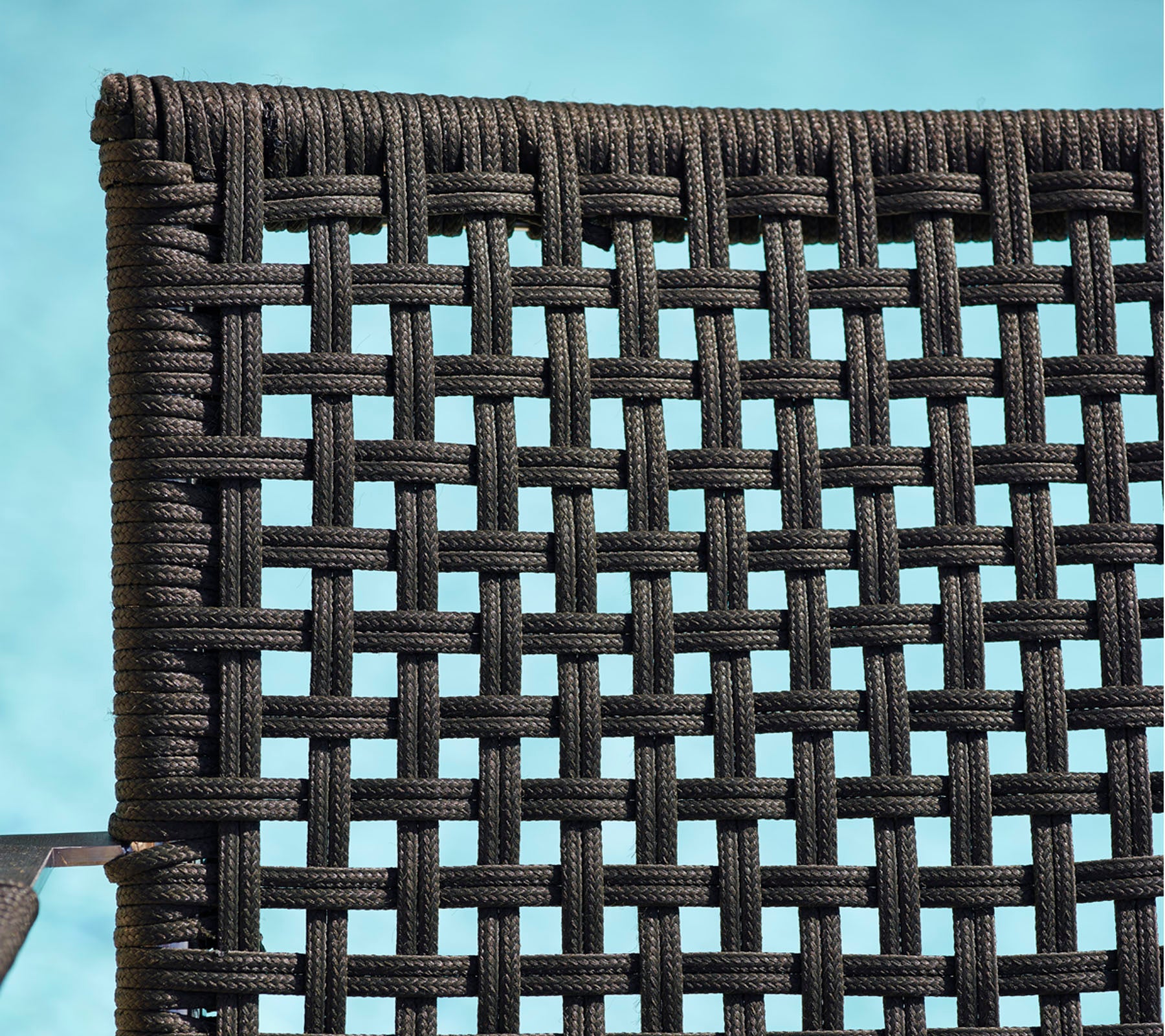 Detailed close-up of a woven black material, showcasing a textured pattern suitable for furniture or decor.