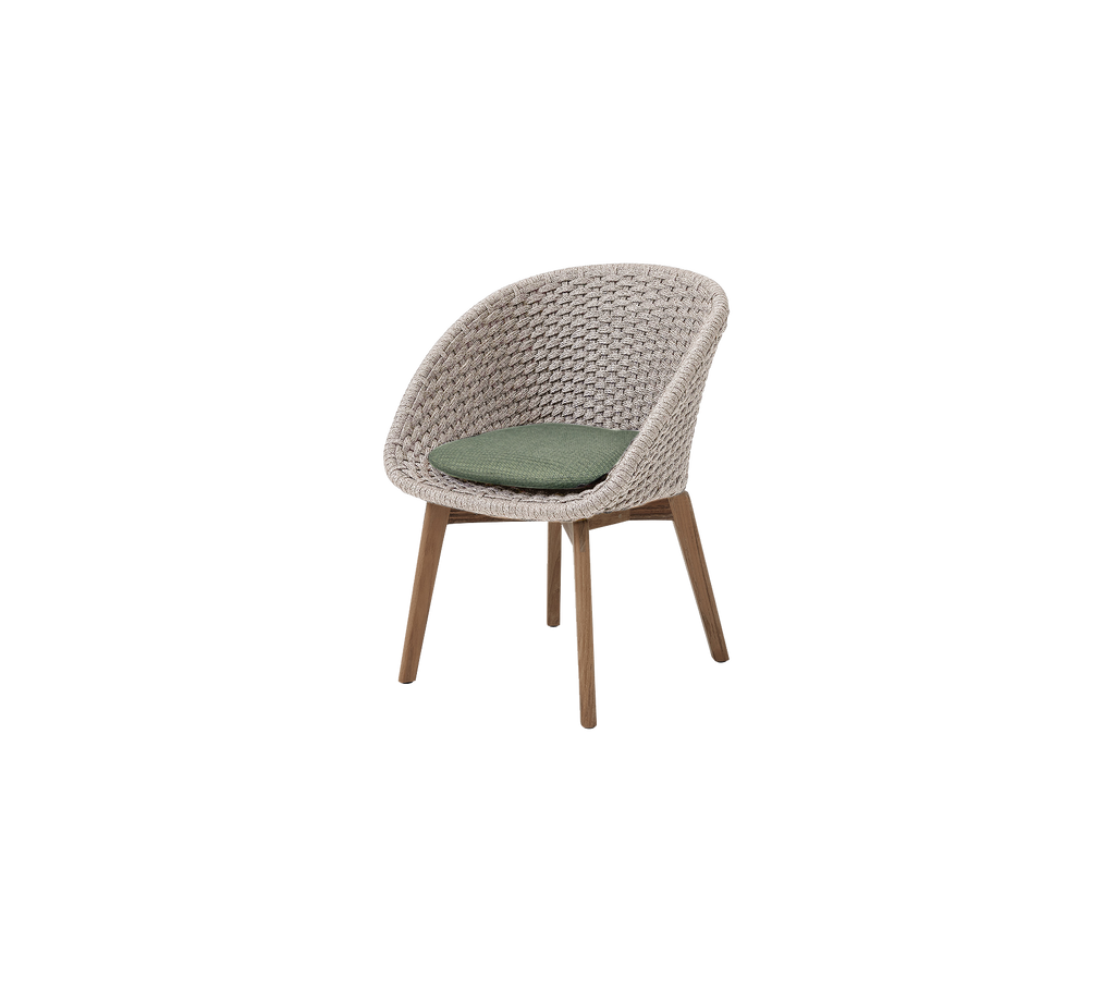 A modern sand/teak chair with a dark green cushion.