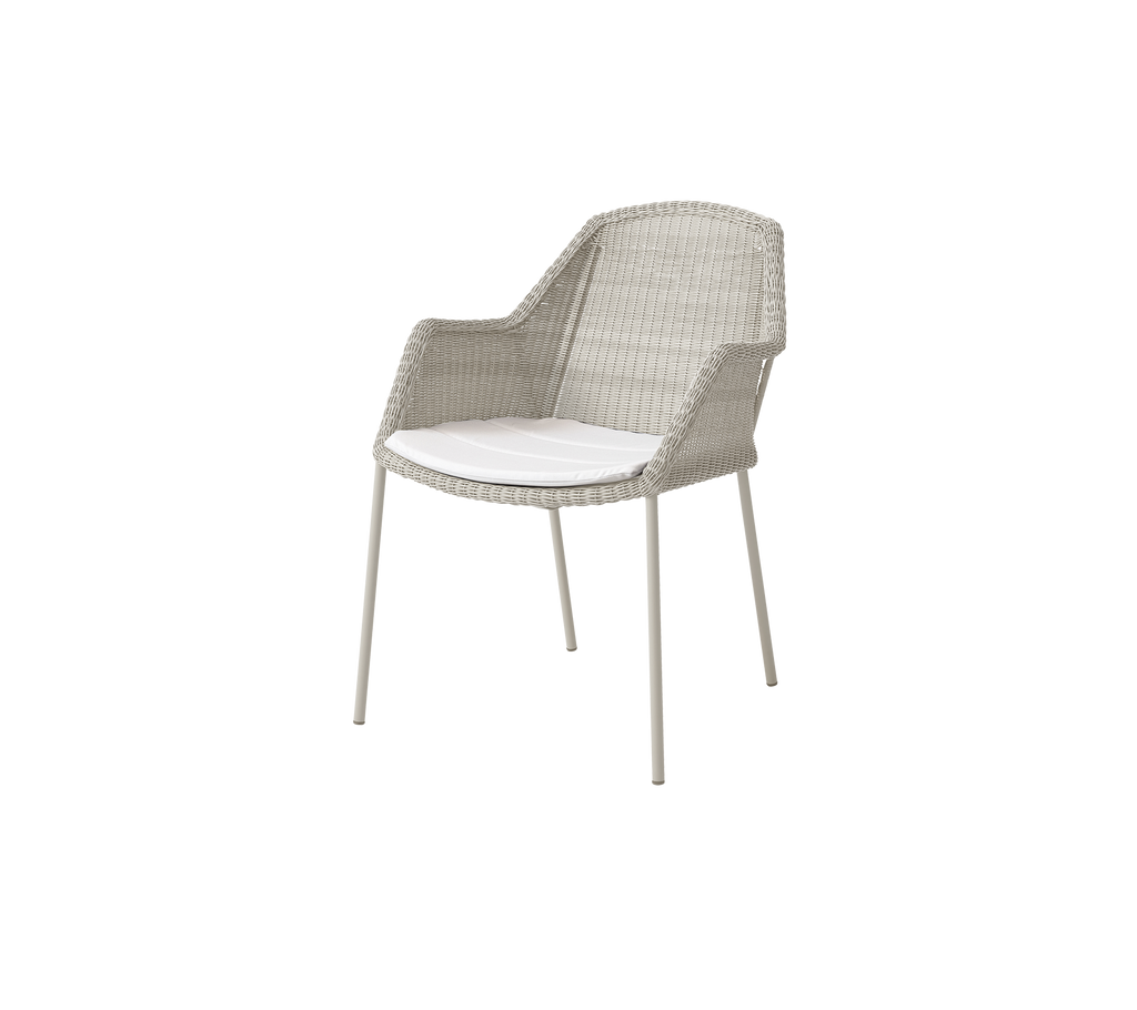 Modern chair with a white cushion in a light sand color.
