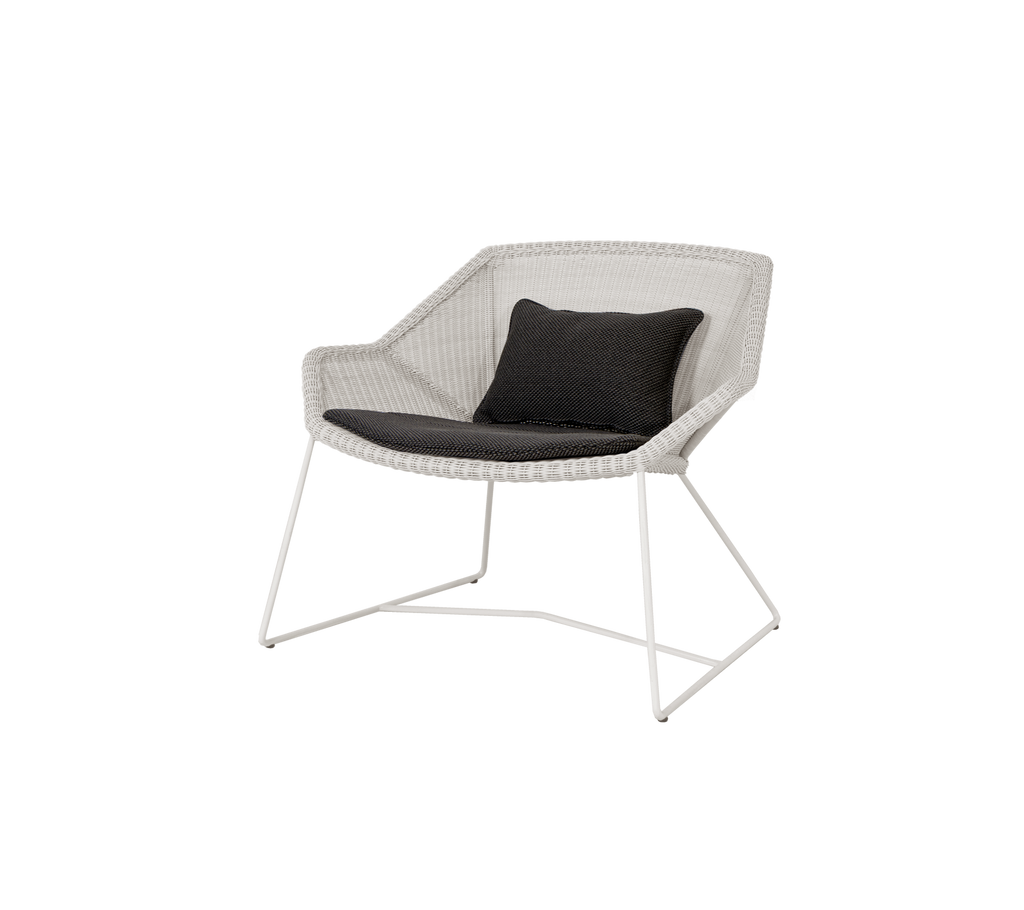Modern chair with a black cushion, featuring a light frame.