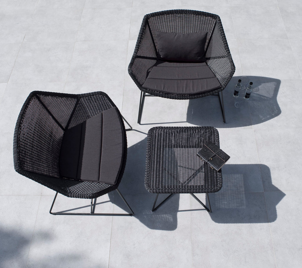 Stylish outdoor seating set featuring two hexagonal chairs and a square table, all in black with minimalist design.
