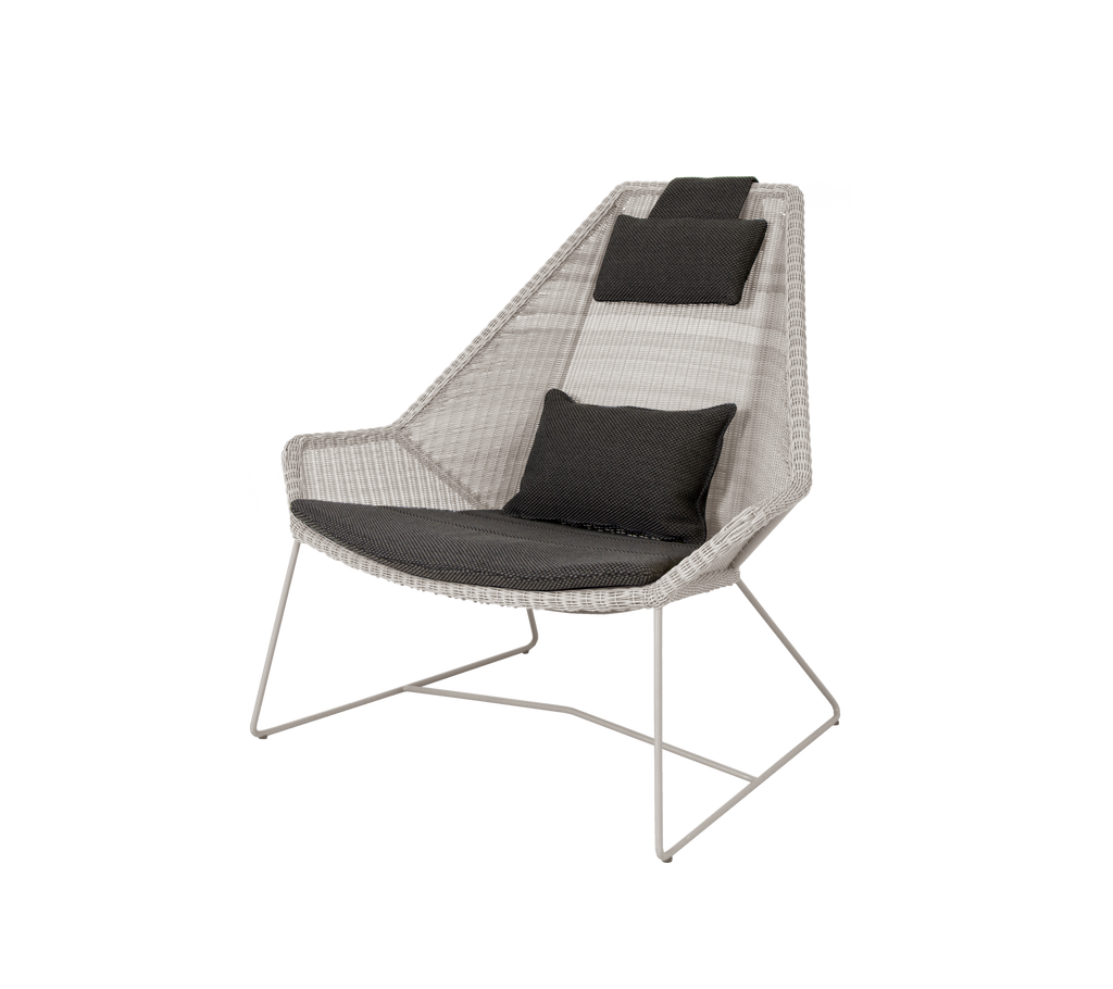 Modern chair with sand frame and dark grey cushion.