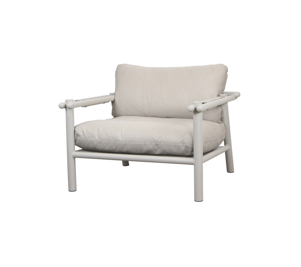 Modern beige chair with a plush cushion and minimalist frame.