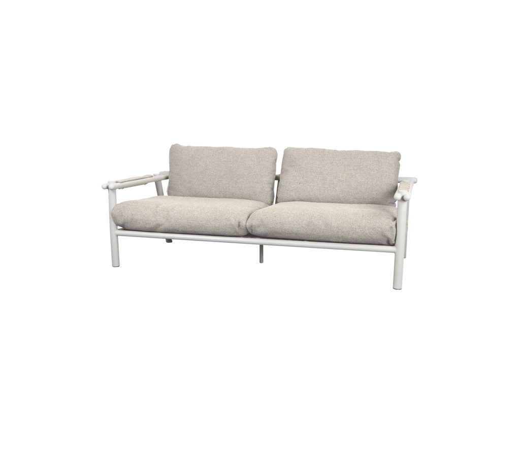 Modern sofa with sand-colored cushions and white frame.