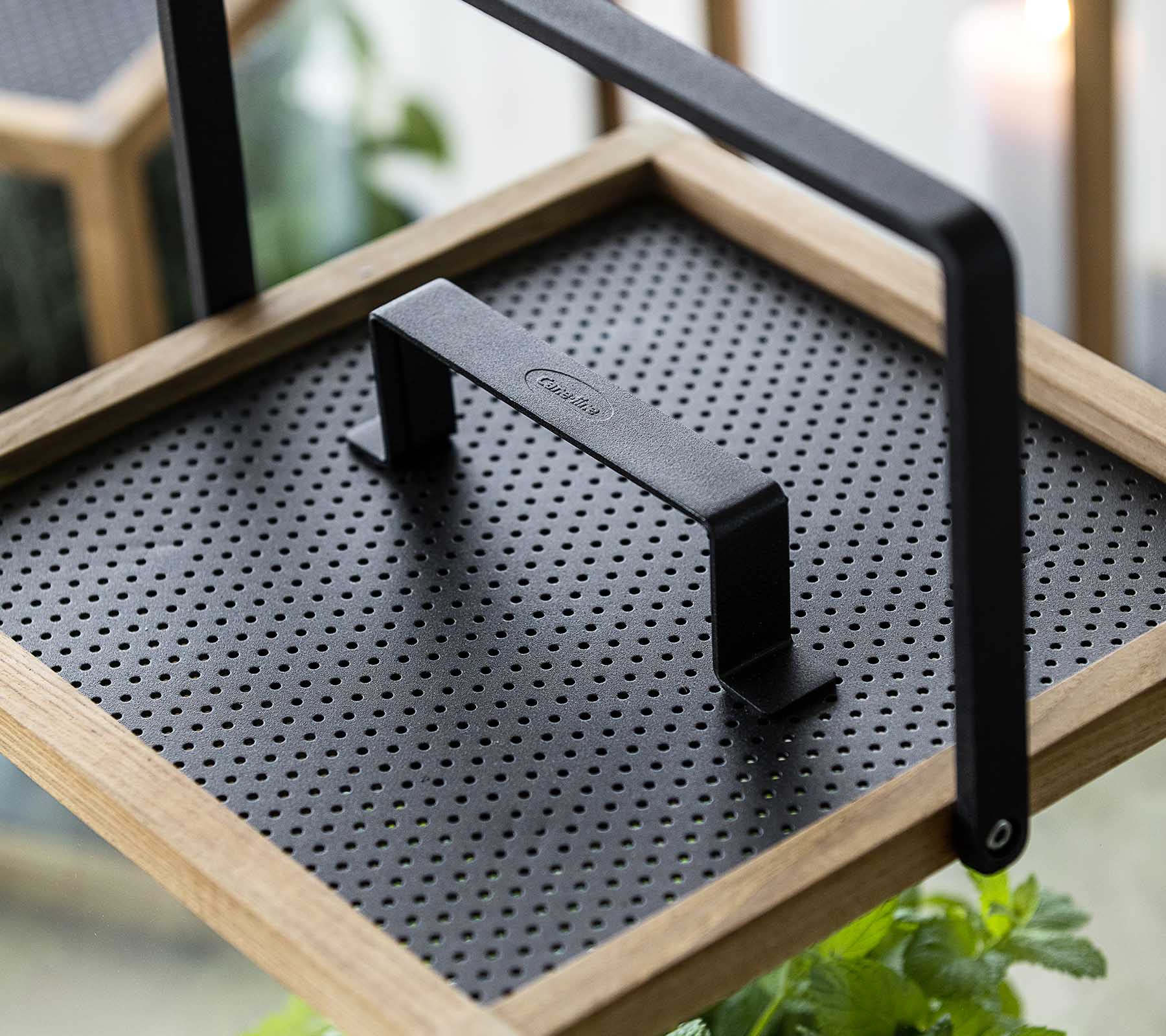 Decorative tray featuring a textured black surface and a sturdy handle, perfect for showcasing plants or serving items.