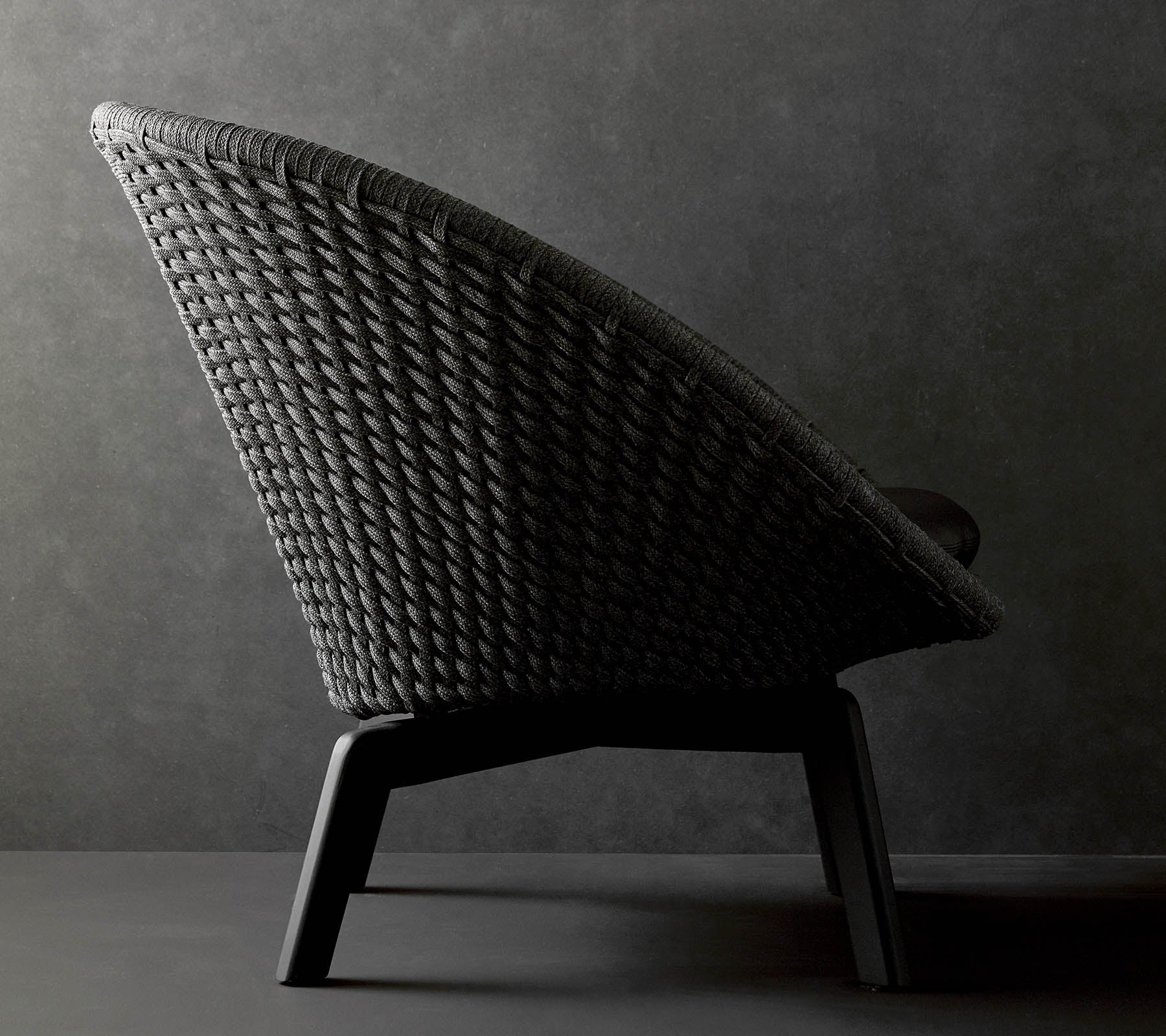 Stylish woven chair with a sleek silhouette and sturdy legs, perfect for modern decor.