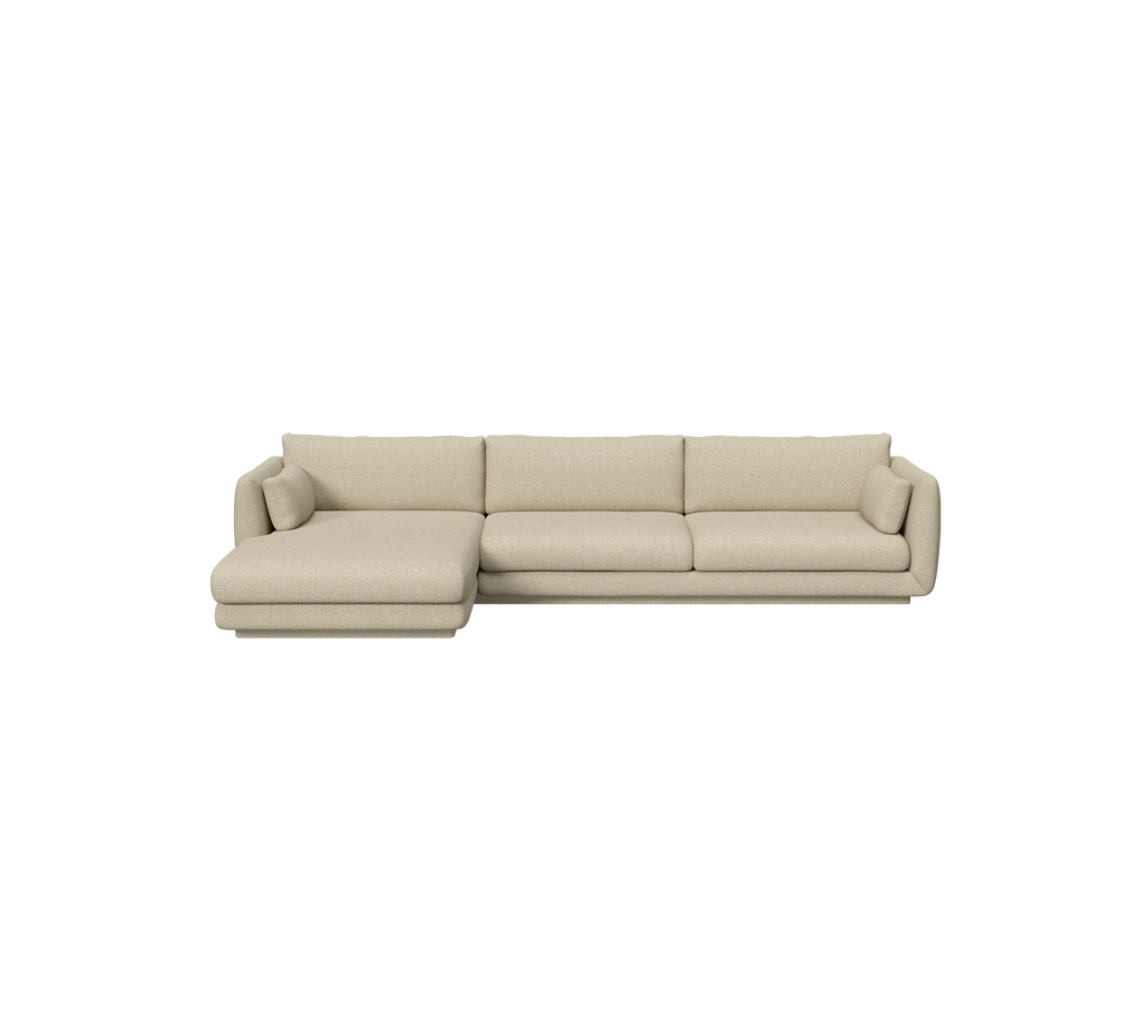 Light brown modern sofa with a chaise section in a spacious lounge setting.