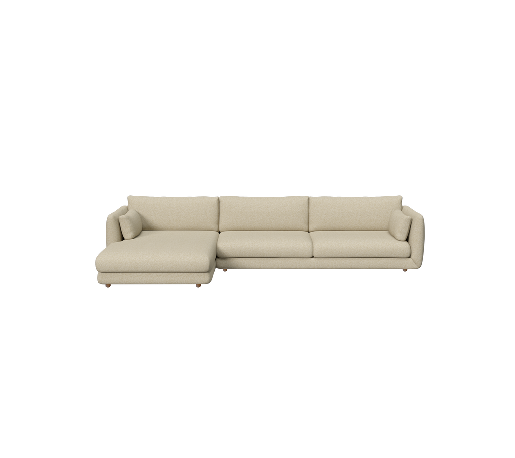 Light brown modern sofa with a chaise section in a lounge setting.