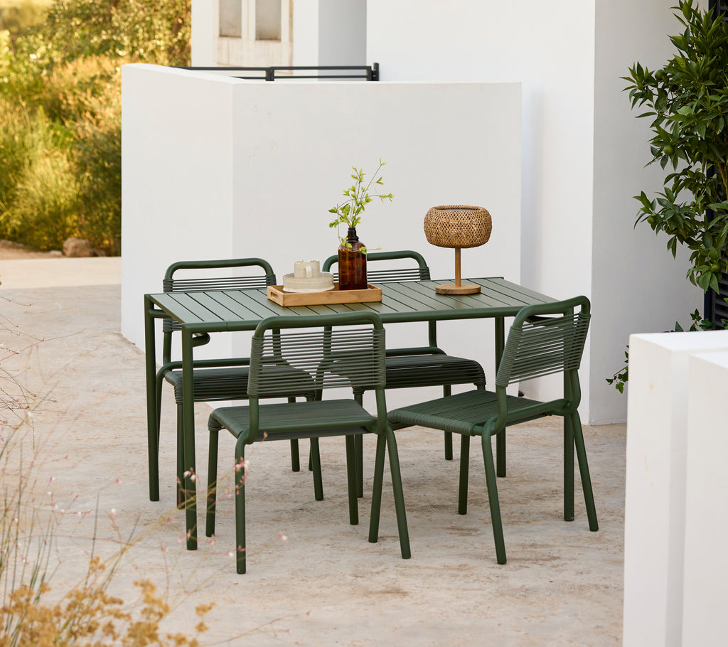 Modern green table with matching chairs set in an outdoor environment.