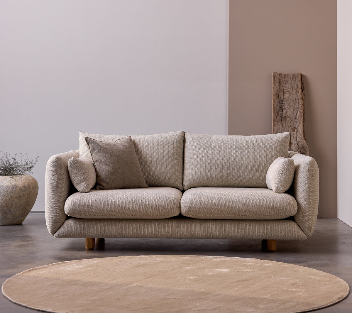 Bloom 2-seater sofa with teak legs in Desert Sand color, featuring plush cushions and a soft, minimalist design.