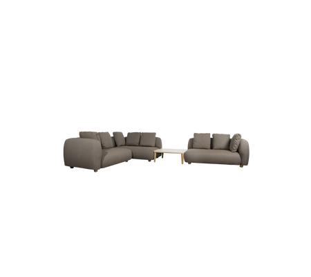 Modern taupe sofa with cushions and a light table in a lounge setting.