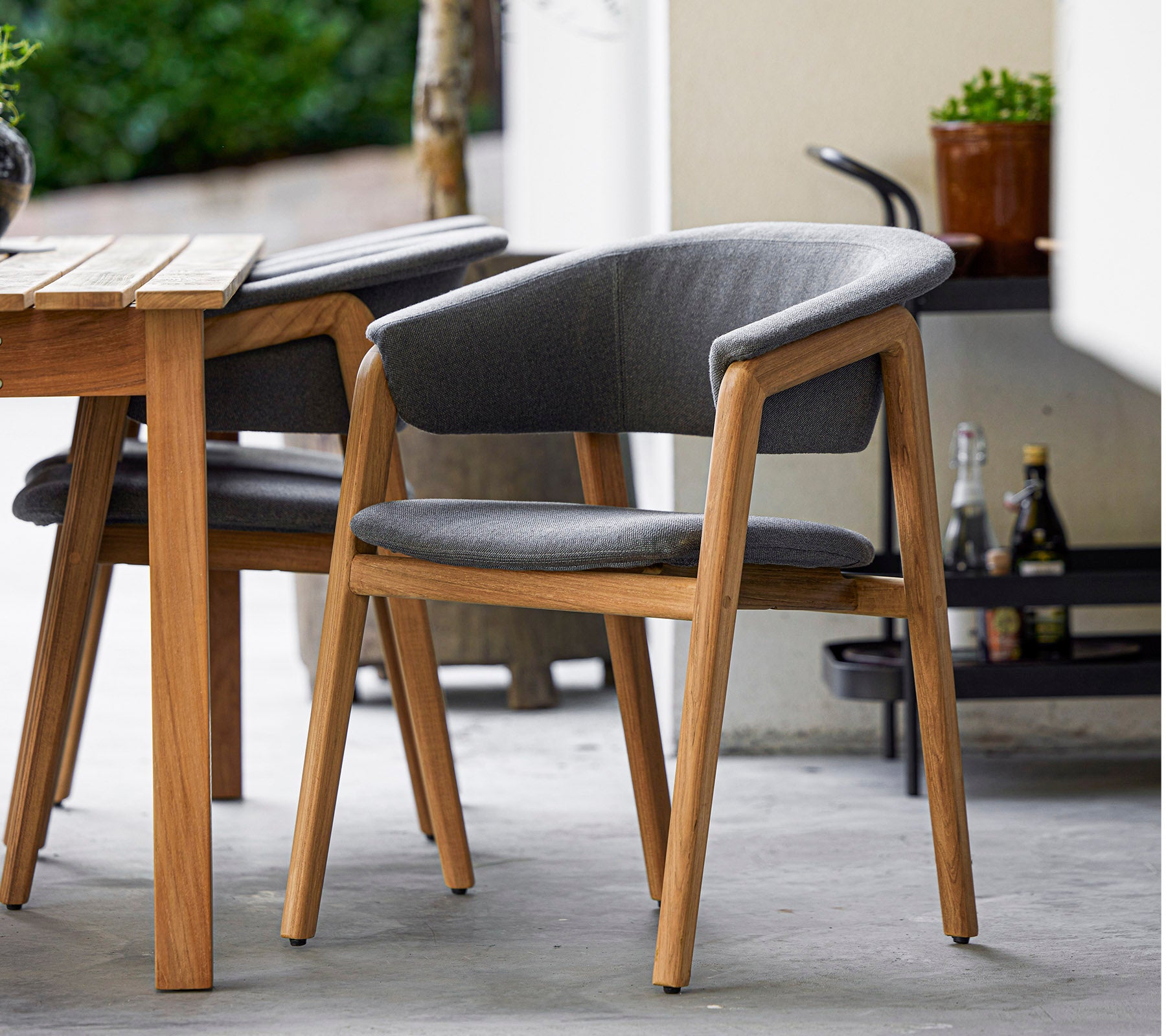 Stylish chair with a wooden frame and grey upholstery, designed for comfort and elegance, perfect for modern settings.