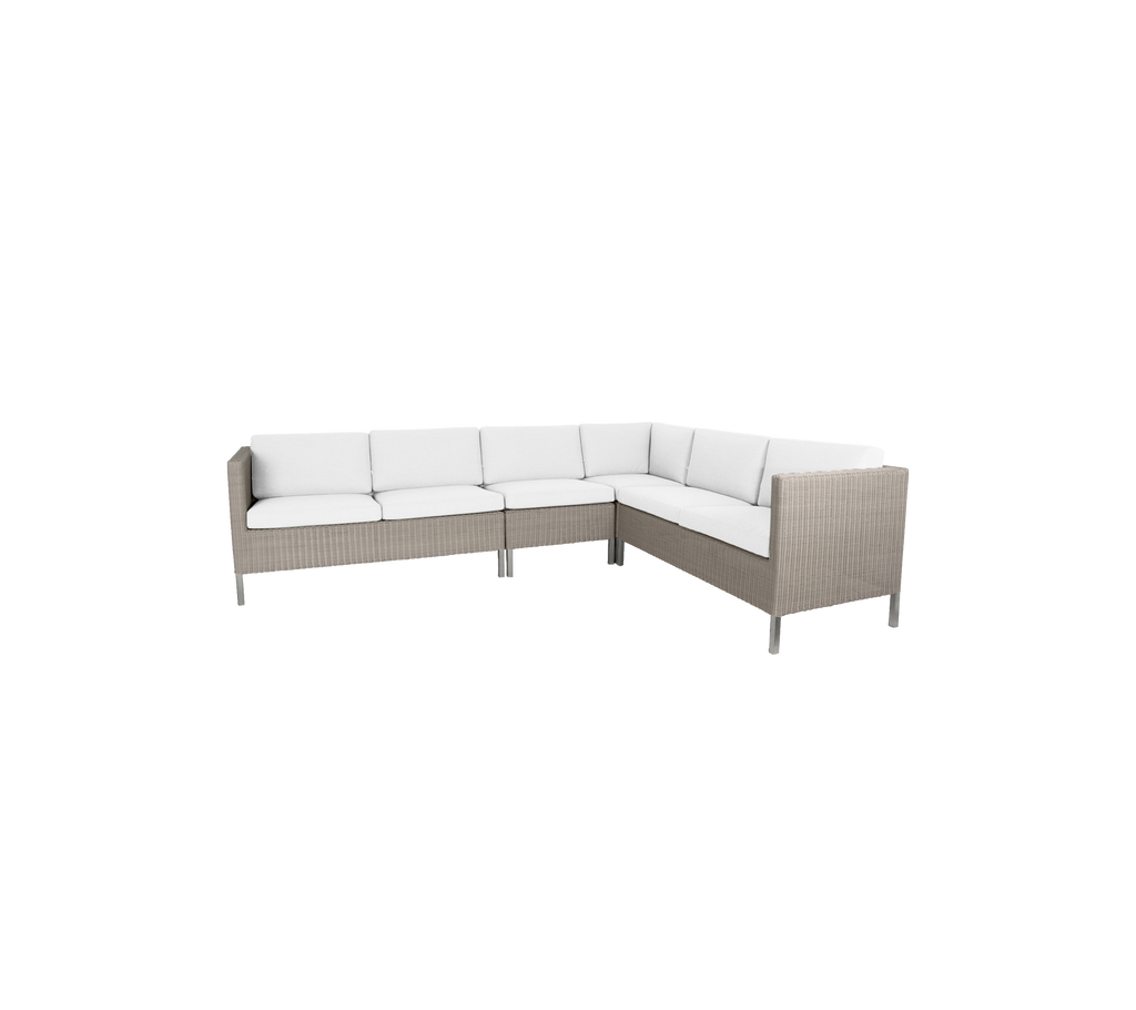 Stylish outdoor corner seating with plush white cushions and a modern wicker design, perfect for gatherings and relaxation.