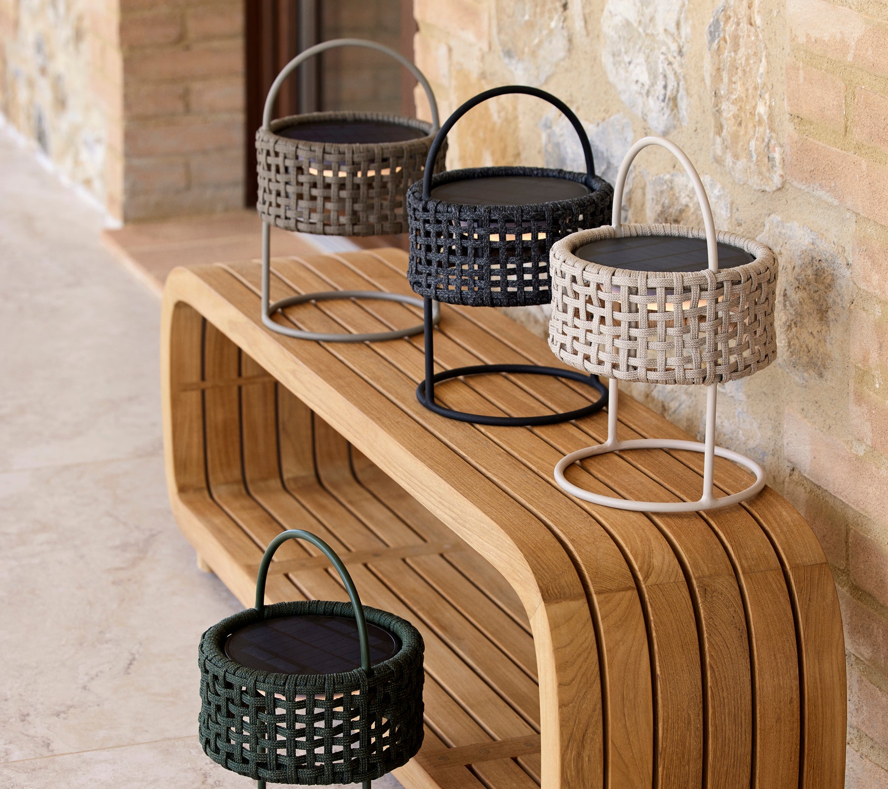 A stylish arrangement of four illusion lamps in various colors on a sleek wooden surface, showcasing modern design and elegance.