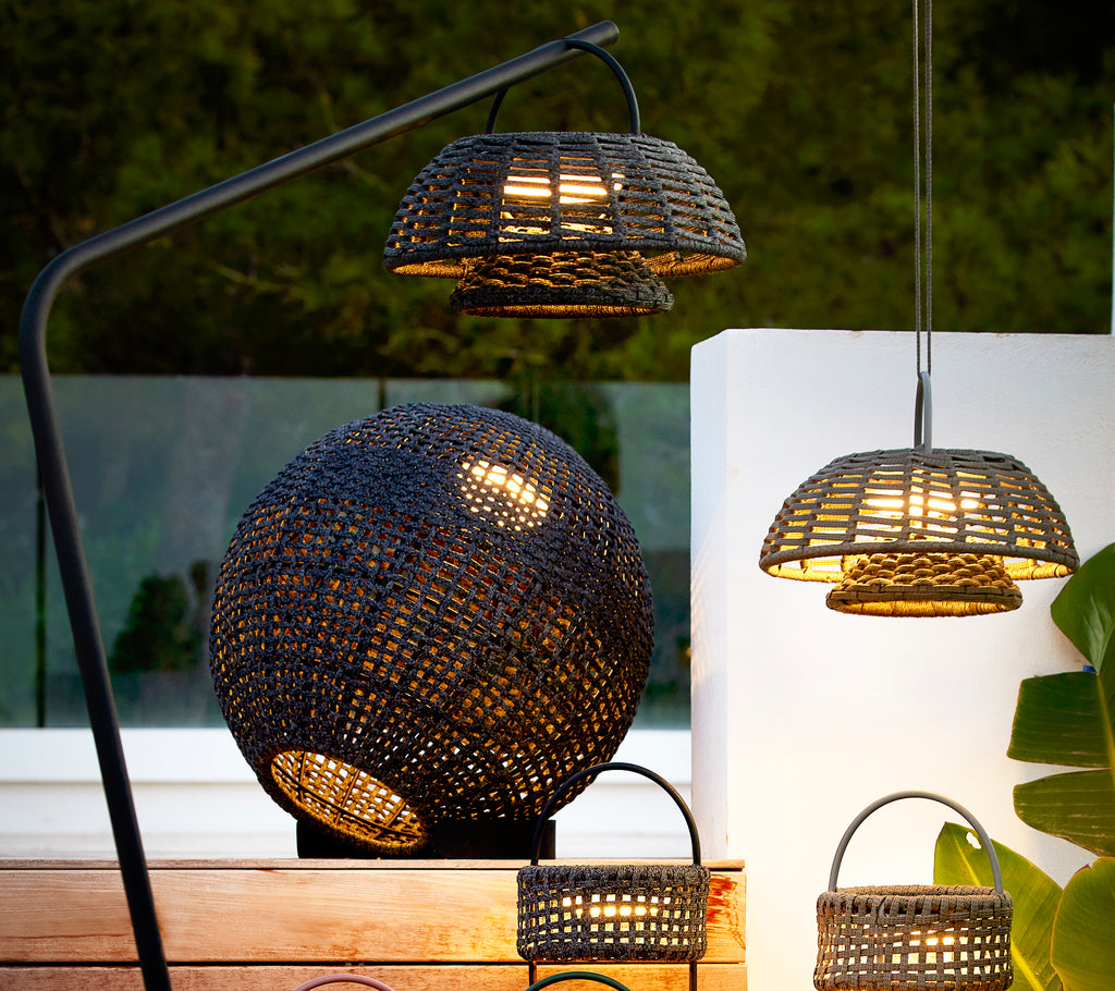Round gray illusion lamp with intricate woven design, accompanied by smaller hanging lamps, creating a stylish and cozy lighting arrangement.