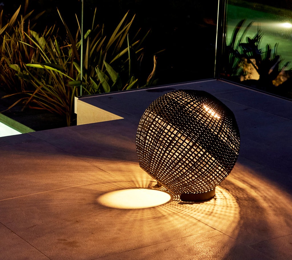 A round illusion lamp casting intricate light patterns on the surface, creating a captivating ambiance.