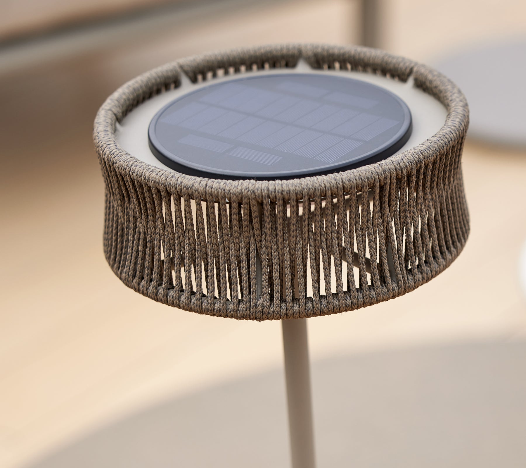 A decorative LED light with a solar panel, featuring a unique woven design that creates an illusion of elegance.