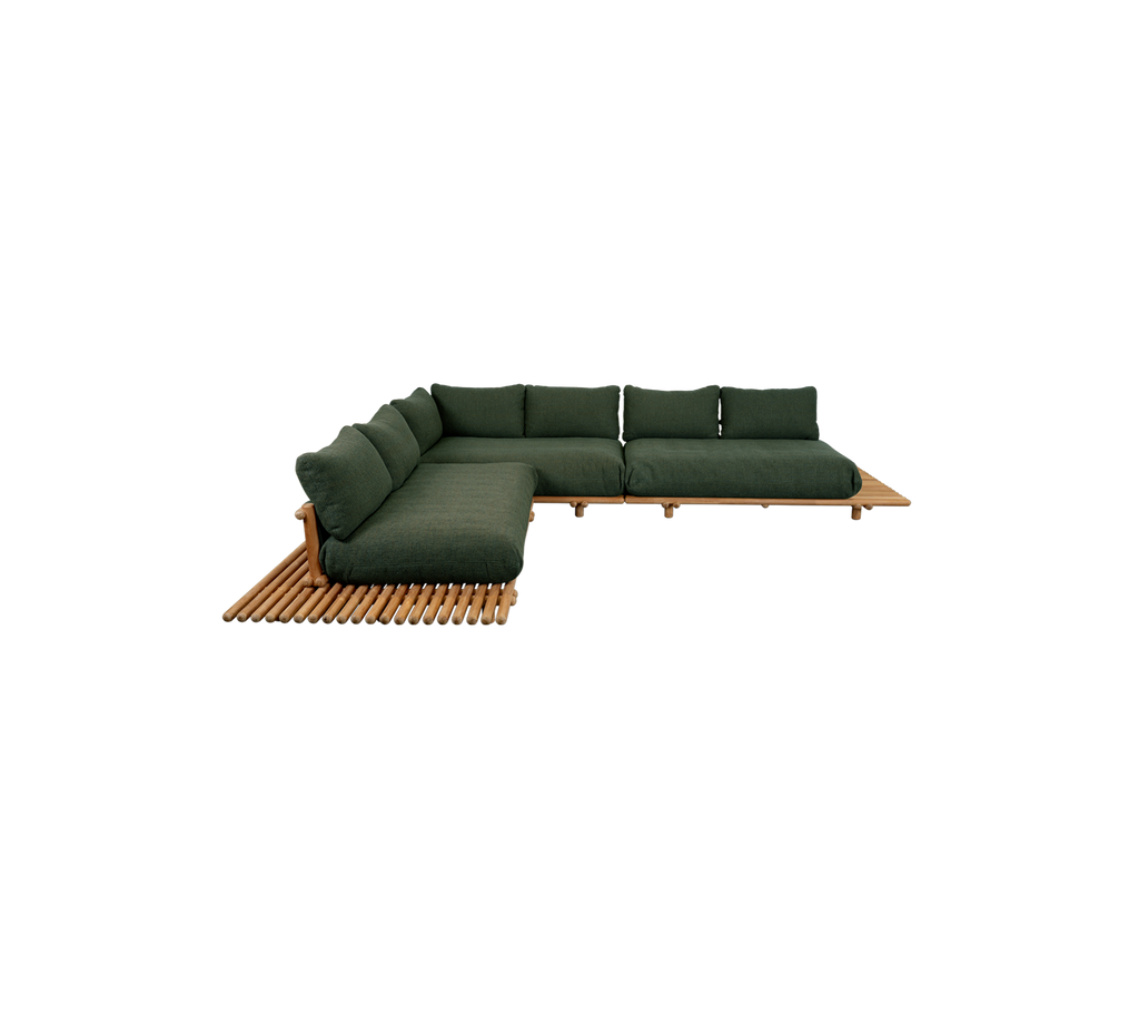 Modern teak sofa with dark green cushions in a lounge setting.