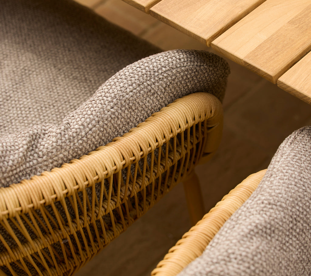 Light brown Rice cushion on a stay dining chair with elegant aluminium legs, showcasing woven detail and a natural aesthetic.