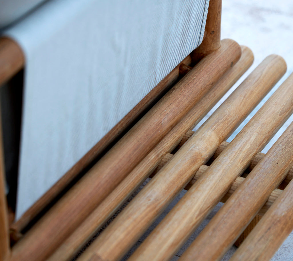 Teak platform with smooth wooden sticks, showcasing a sleek design and hidden back support for added comfort.