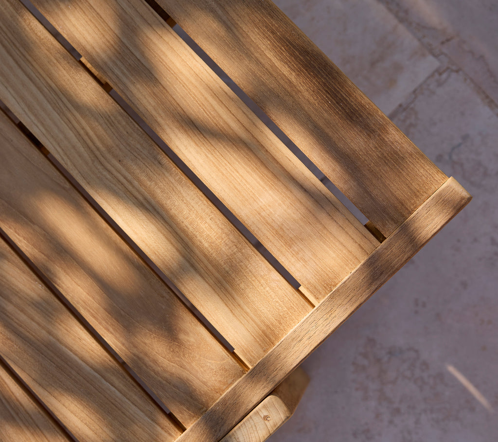 Close-up of a wooden slat surface with light shadows.