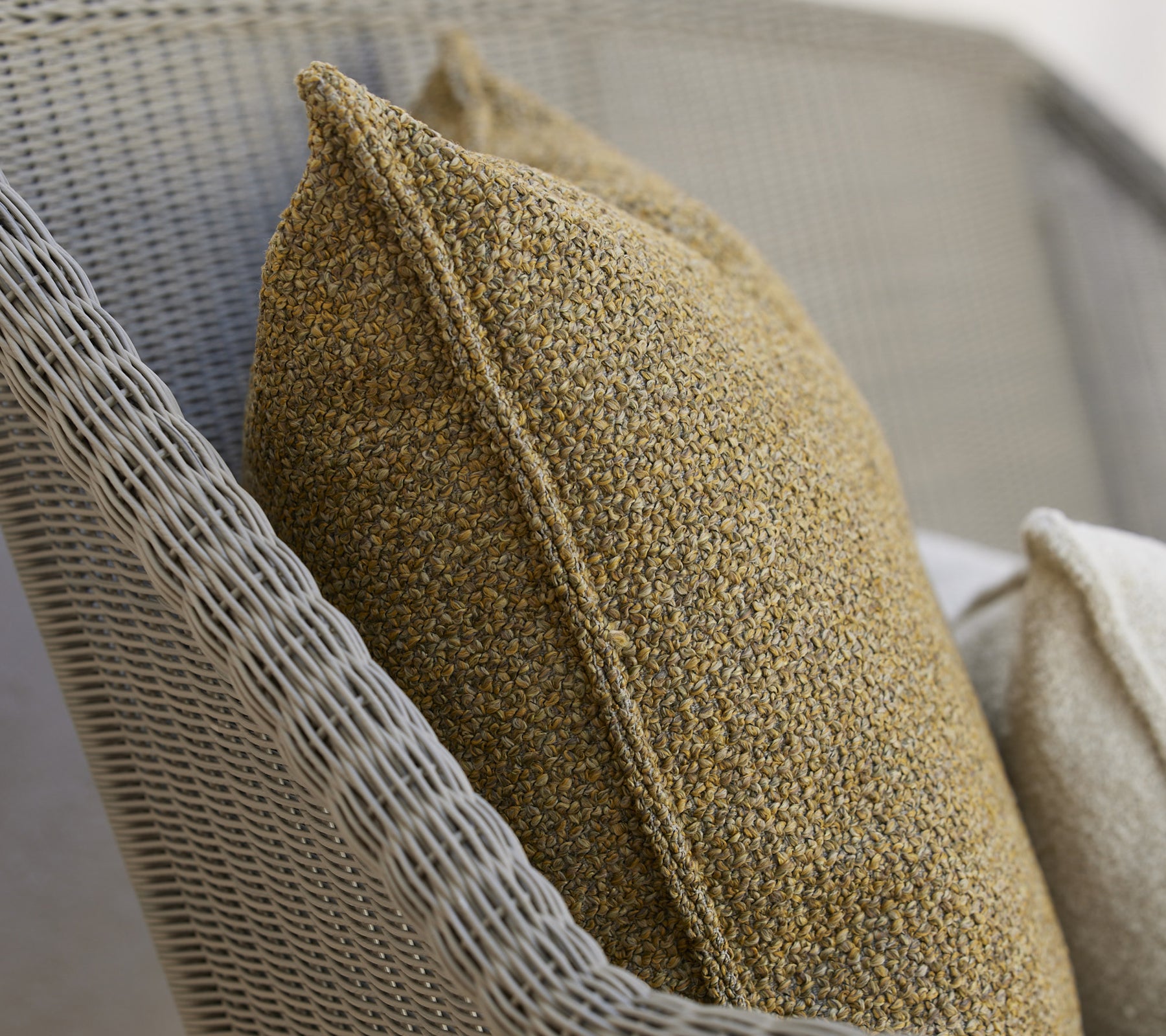 Textured cushions in warm tones on a woven surface, providing a cozy and stylish accent for relaxation.